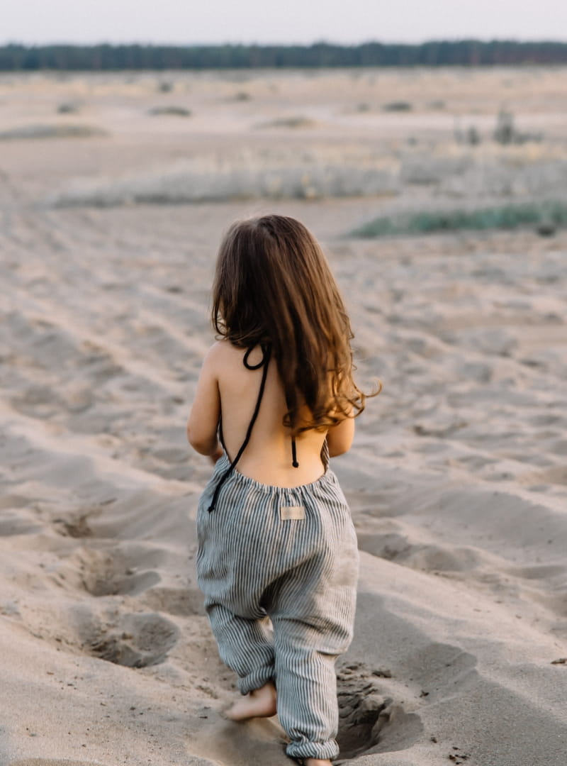 Baggy striped, linen children's trousers tied oversize