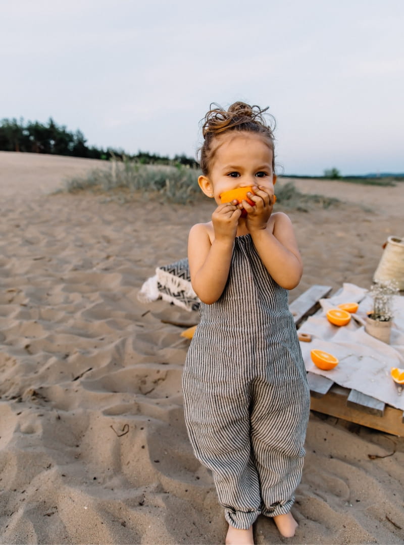 Baggy striped, linen children's trousers tied oversize