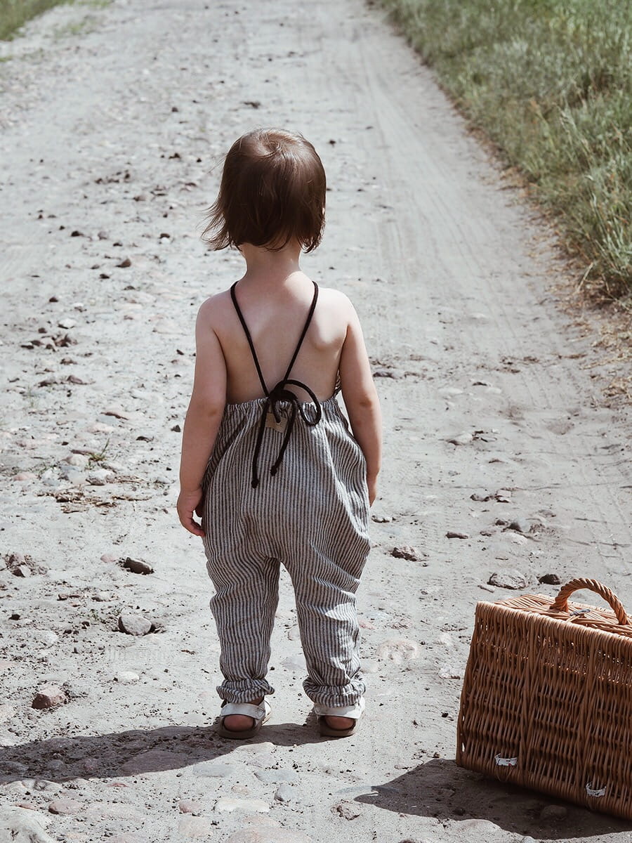 Baggy striped, linen children's trousers tied oversize